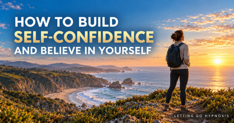 A woman standing confidently on a coastal headland at sunrise with the words How to Build Self-Confidence and Believe in Yourself