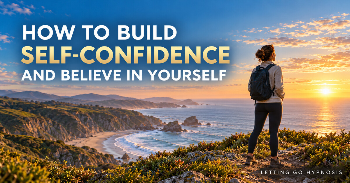 A woman standing confidently on a coastal headland at sunrise with the words How to Build Self-Confidence and Believe in Yourself