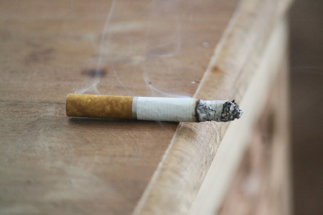 A cigarette resting on a plain surface, representing the choice to get back on track after a smoking slip.