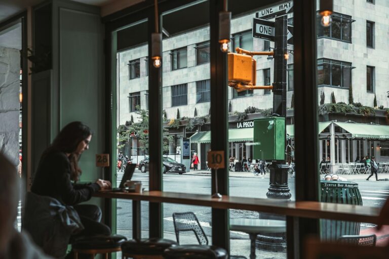 A person sitting quietly at a table after a conversation, reflecting without continuing to replay it.