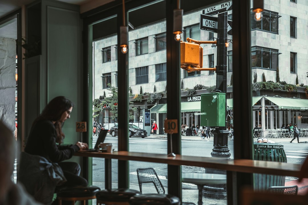 A person sitting quietly at a table after a conversation, reflecting without continuing to replay it.